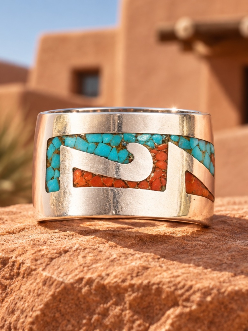 A Navajo Sterling Silver band ring with Coral and Turquoise inlay. Tested